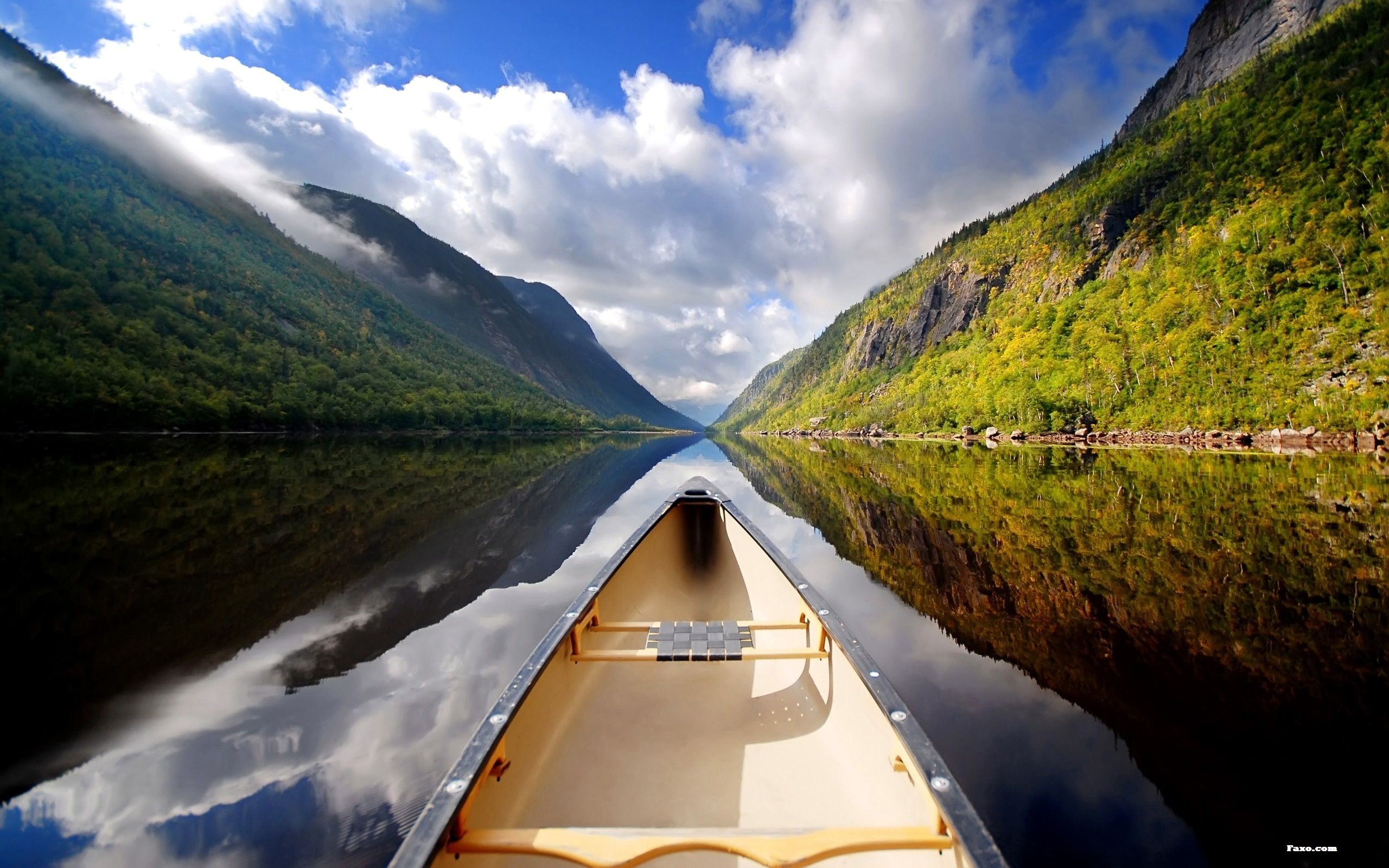 Kayak in a Calm River Between Two Mountains Wallpaper