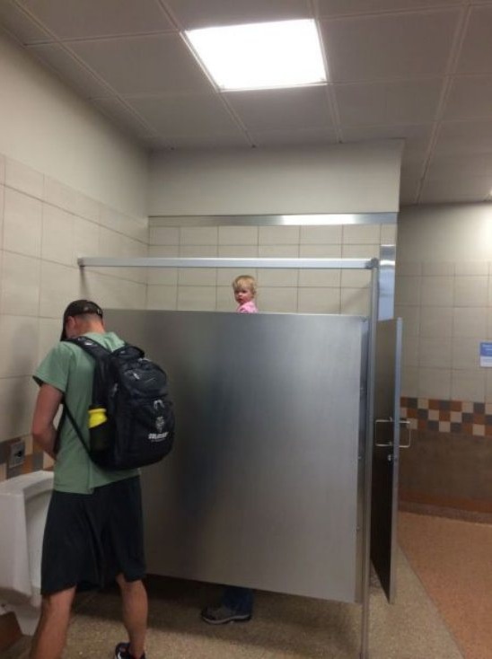 Urinal Peekaboo - Little Girl Peeks Over Bathroom Stall - Too Tall Baby